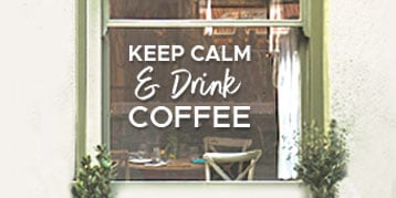 Café vindue med tekst trykt på vinduesfolie