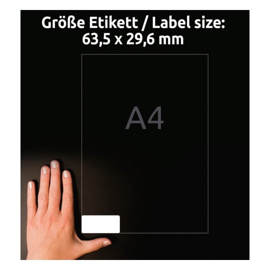 Billedet viser en hånd placeret ved siden af en gennemsigtig etiket. Det angiver etiketstørrelsen 63,5 x 29,6 mm og baggrunden i A4-format.