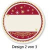 Billedet viser en cirkulær dekorativ etiket med en maroon sektion øverst, prydet med forskellige snefnug. Den nederste halvdel er blank, muligvis til skrift, og har et dekorativt element med krøller. Nederst står der 'Design 2 von 3.'