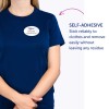 Billedet viser en person iført en blå skjorte med en selvklæbende navneskilt, der lyder 'B. Carlos, Marketing Director.' Teksten fremhæver skiltets klæbende egenskab, som angiver, at det klæber pålideligt og kan fjernes uden at efterlade rester.