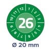 Billedet viser en cirkulær skive med en grøn baggrund, der viser tallet 26 i midten. Omkring midten er der numre fra 1 til 12. Under skiven er der en etiket, der angiver en diameter på 20 mm.